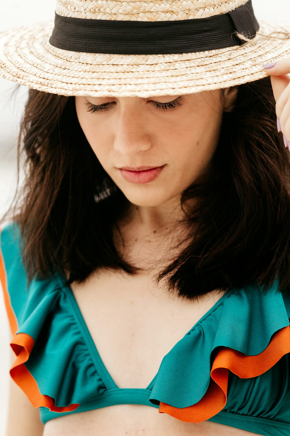 woman in blue shirt wearing white sun hat
