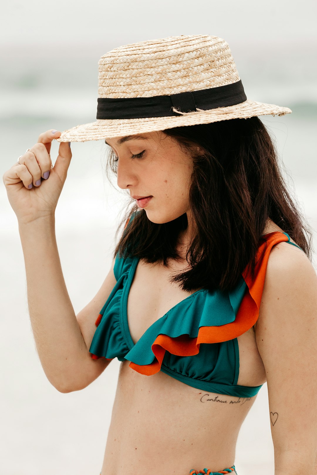 woman in blue tank top wearing brown straw hat