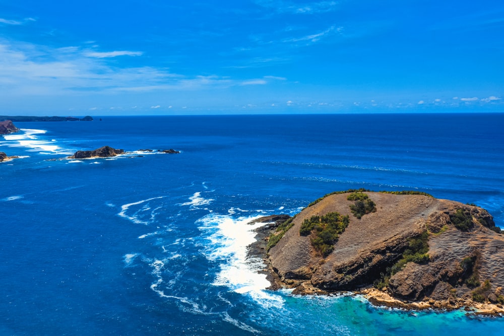 green and brown island under blue sky during daytime