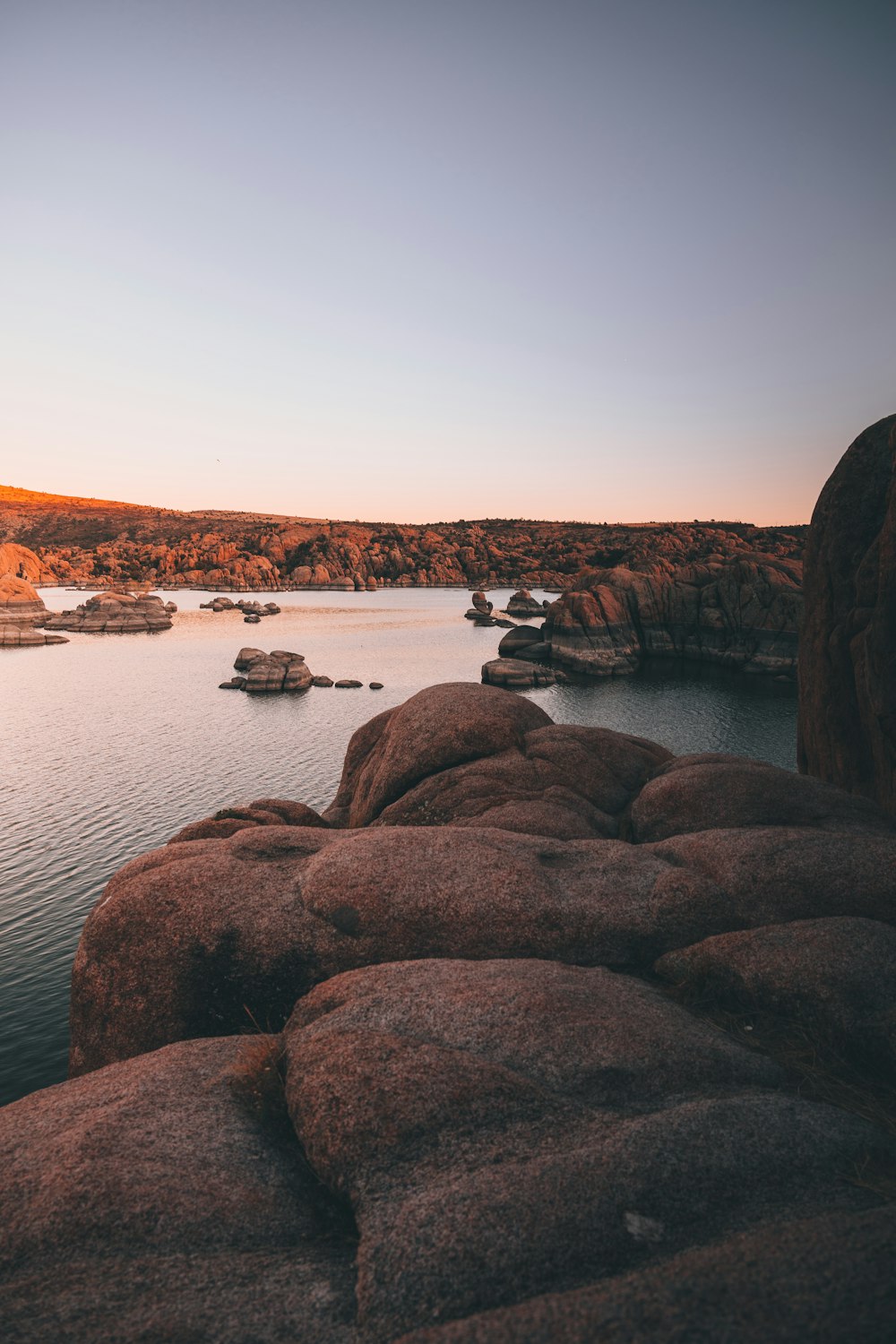 brown rock formation near body of water during daytime