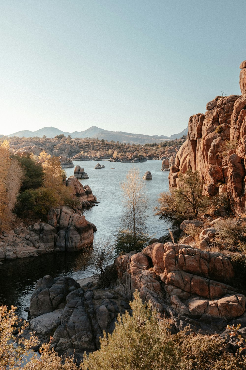 brown rock formation near body of water during daytime