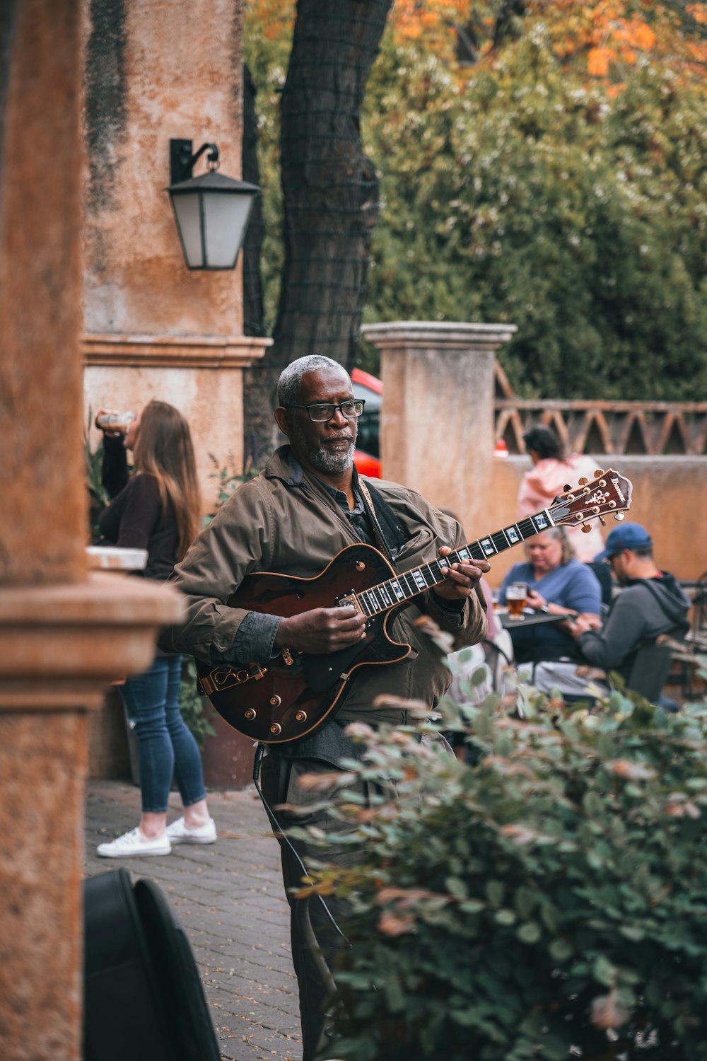 man in black jacket playing electric guitar