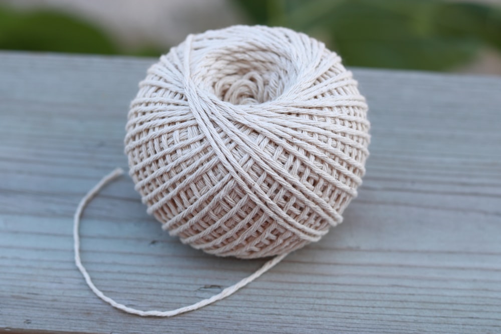 white yarn on gray wooden table