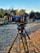 A professional camera setup capturing a lively outdoor event with a scenic coastal backdrop.