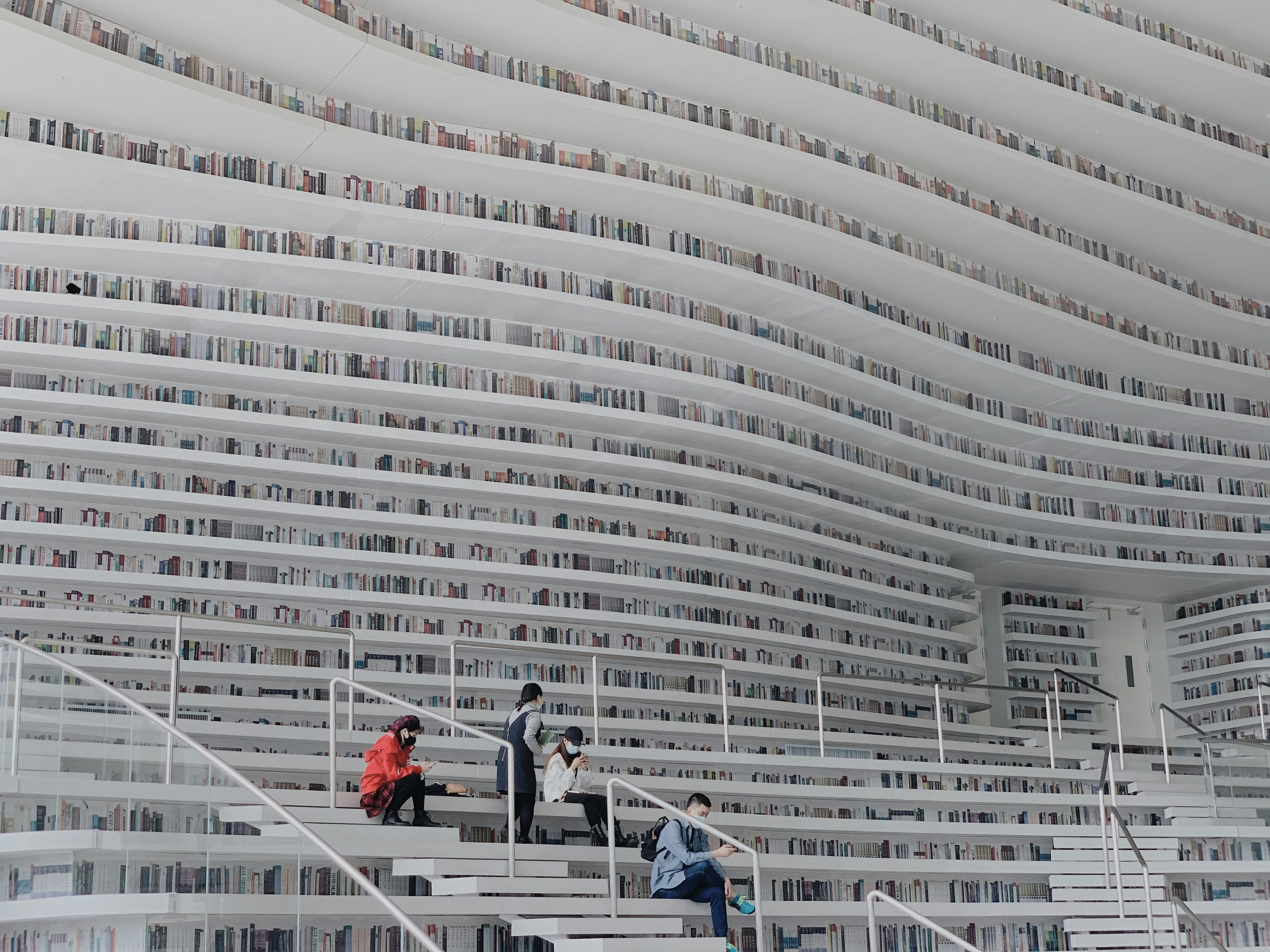 people walking on white concrete stairs