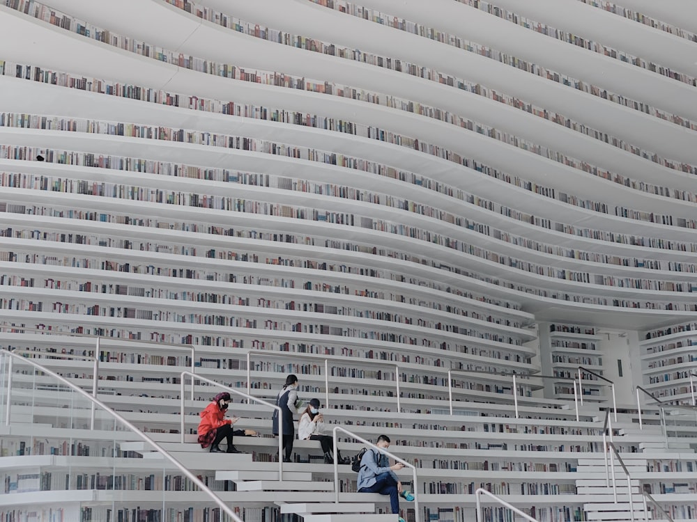 people walking on white concrete stairs