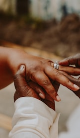 person wearing silver diamond ring