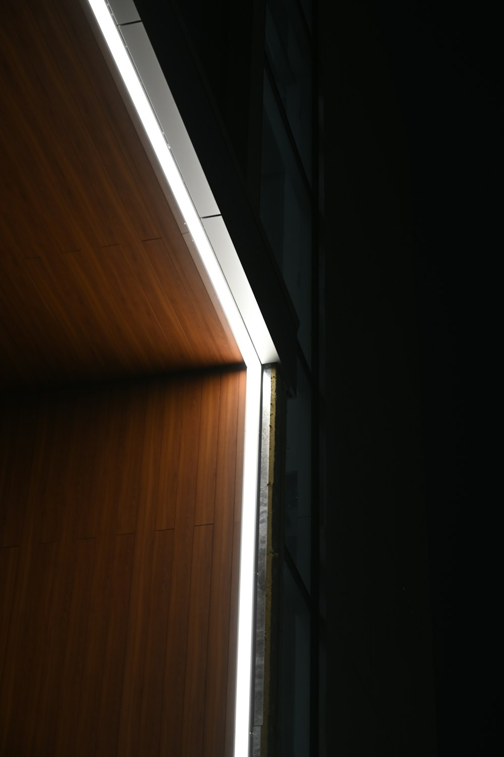 brown wooden cabinet near white wall