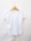 A plain white t-shirt is displayed on a wooden hanger against a light background. The t-shirt is short-sleeved and appears to be made of a lightweight material.