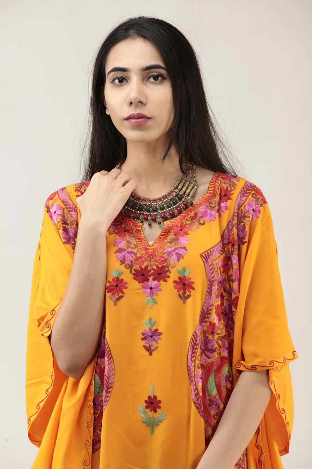 woman in yellow and red floral dress