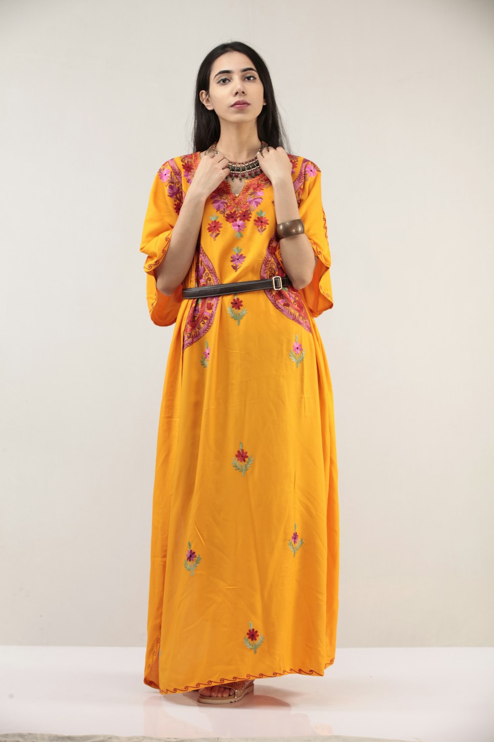 woman in yellow and white floral dress