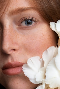 woman with white flower on her ear