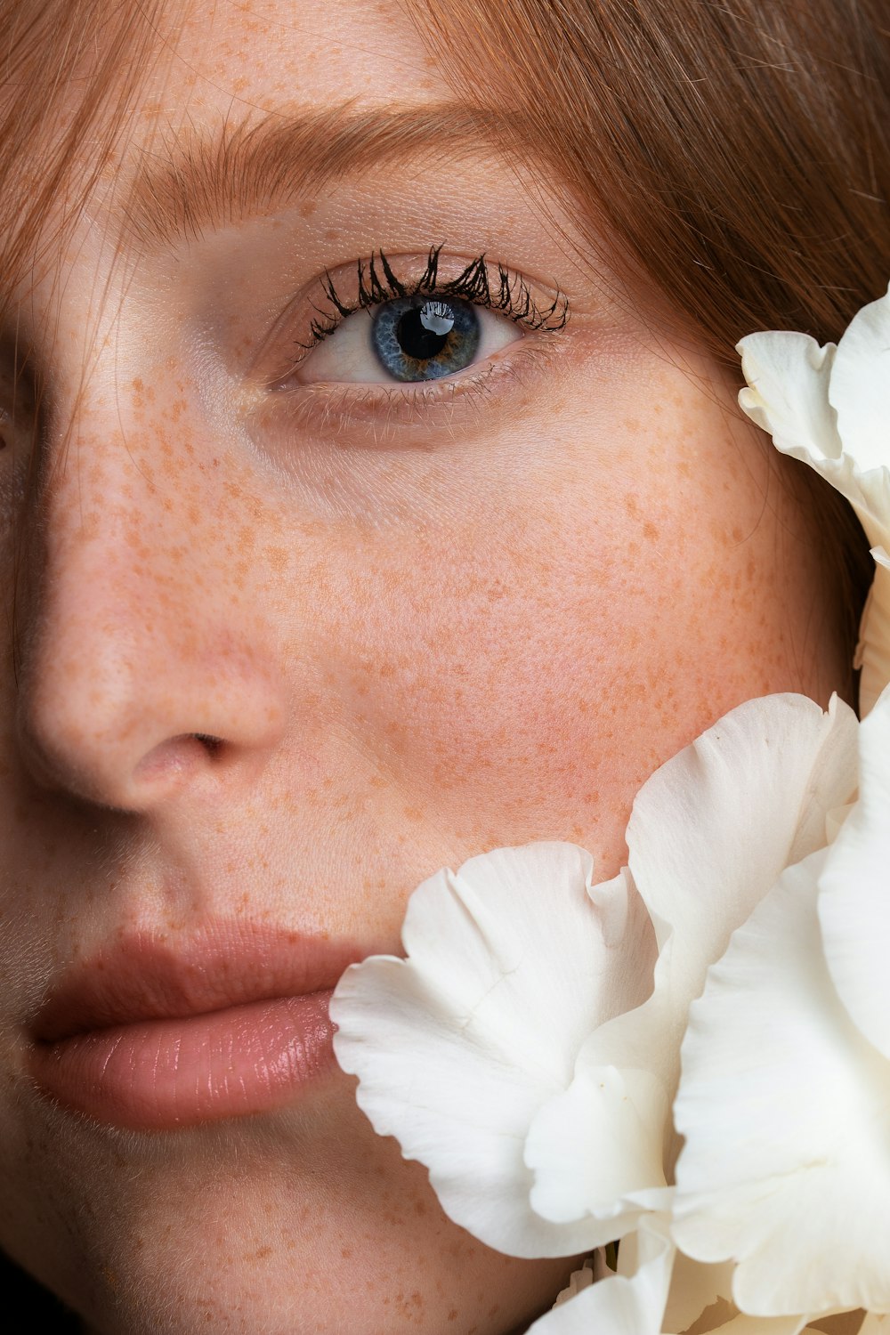 woman with white flower on her ear