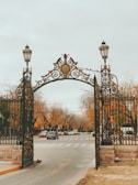 black metal gate near road during daytime