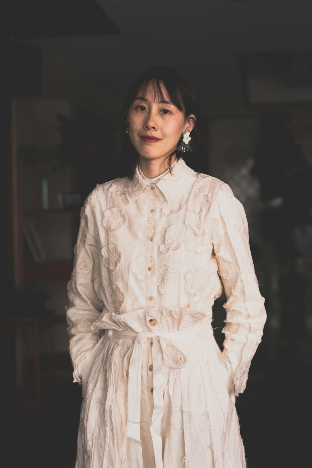 woman in white and brown floral long sleeve dress