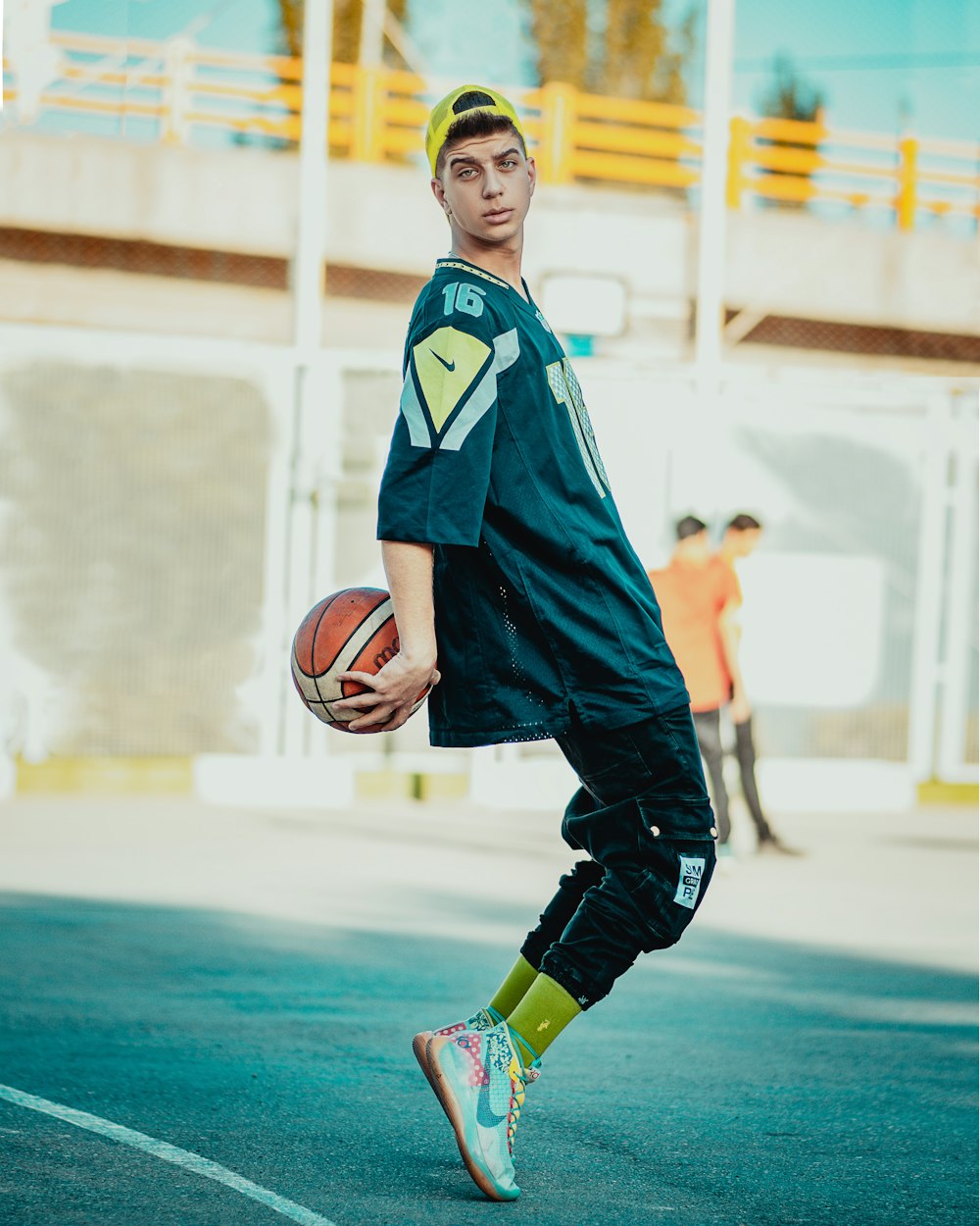 boy in blue jersey shirt holding basketball