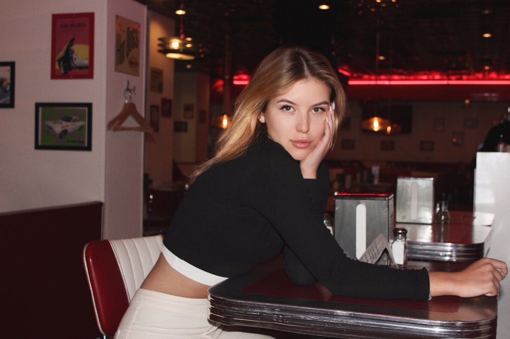 woman in black long sleeve shirt sitting on black leather chair