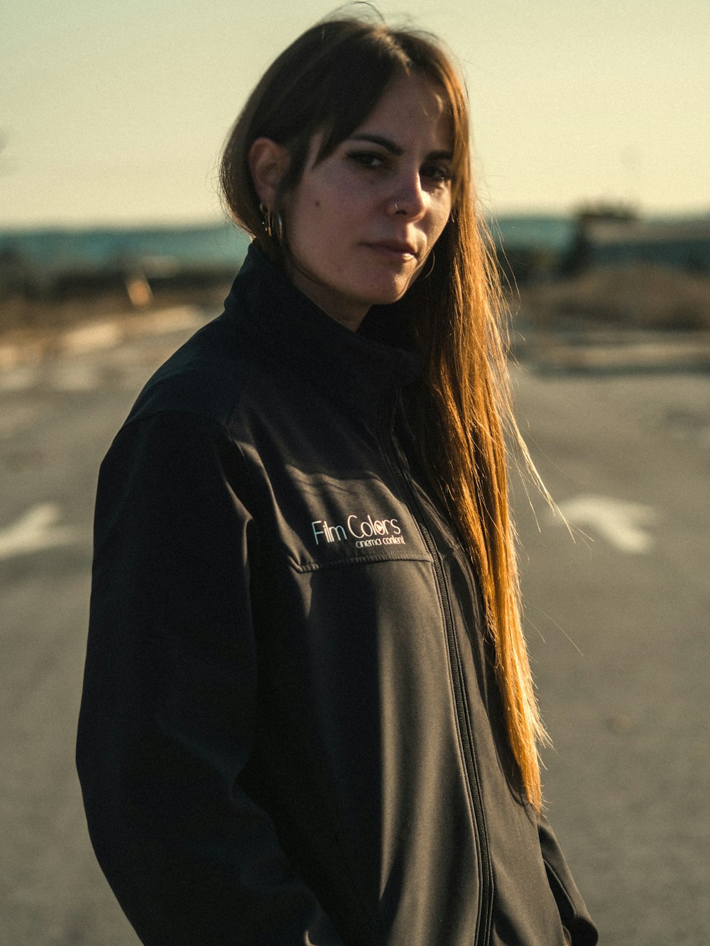 a woman standing in the middle of a road