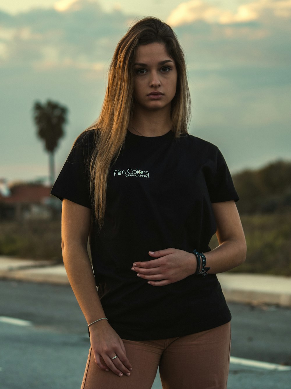 woman in black crew neck t-shirt standing on road during daytime