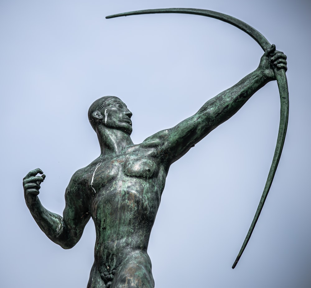 statue of man holding sword