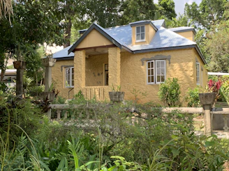 Charming tropical house with lush greenery under bright Cape Verdean sun.