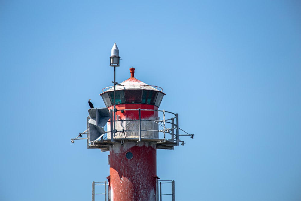 red and white lighthouse under blue sky during daytime