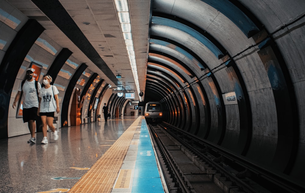 person walking on tunnel during daytime