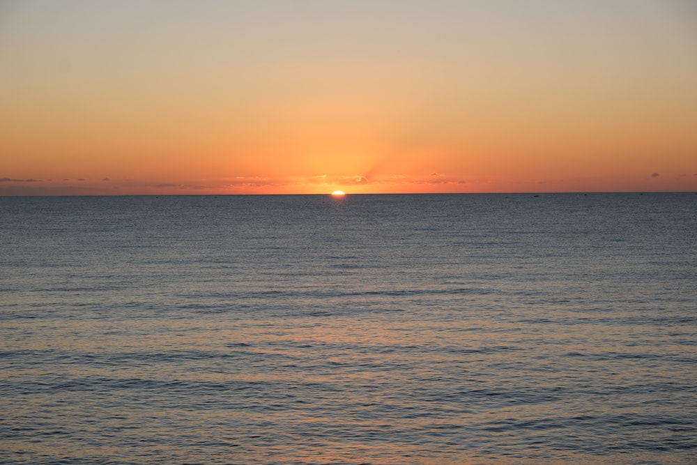 body of water during sunset