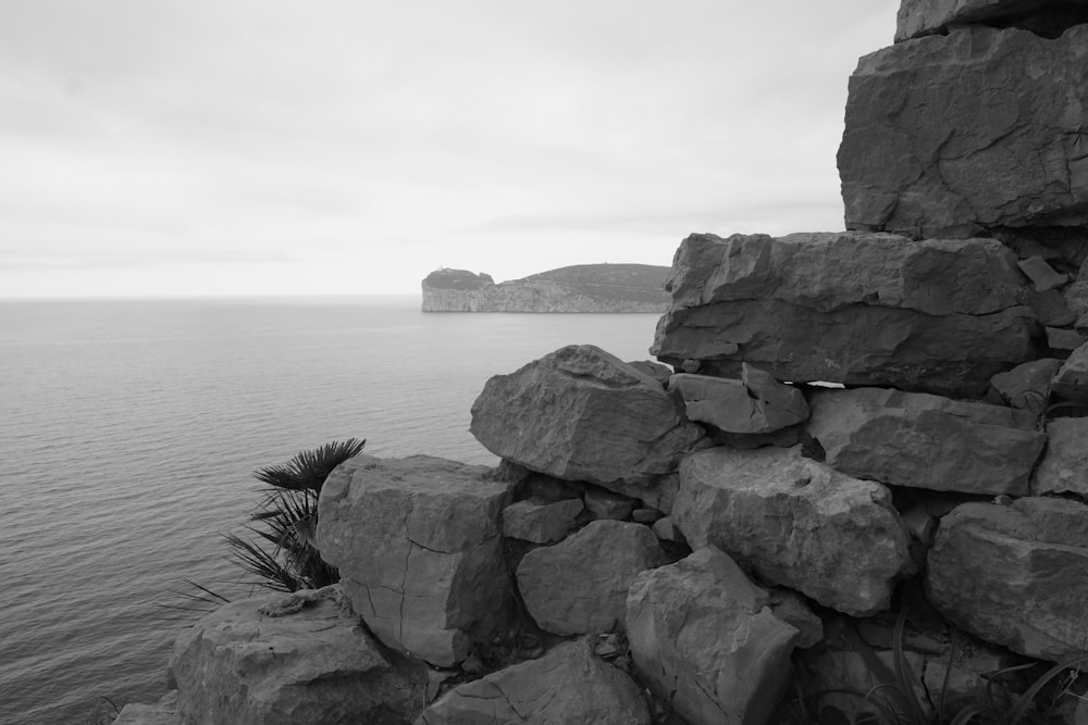 gray rock formation near body of water during daytime