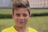 boy in yellow crew neck shirt smiling