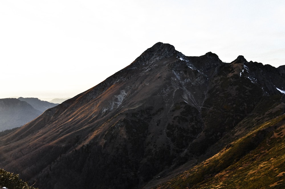 brown and black mountain under white sky during daytime