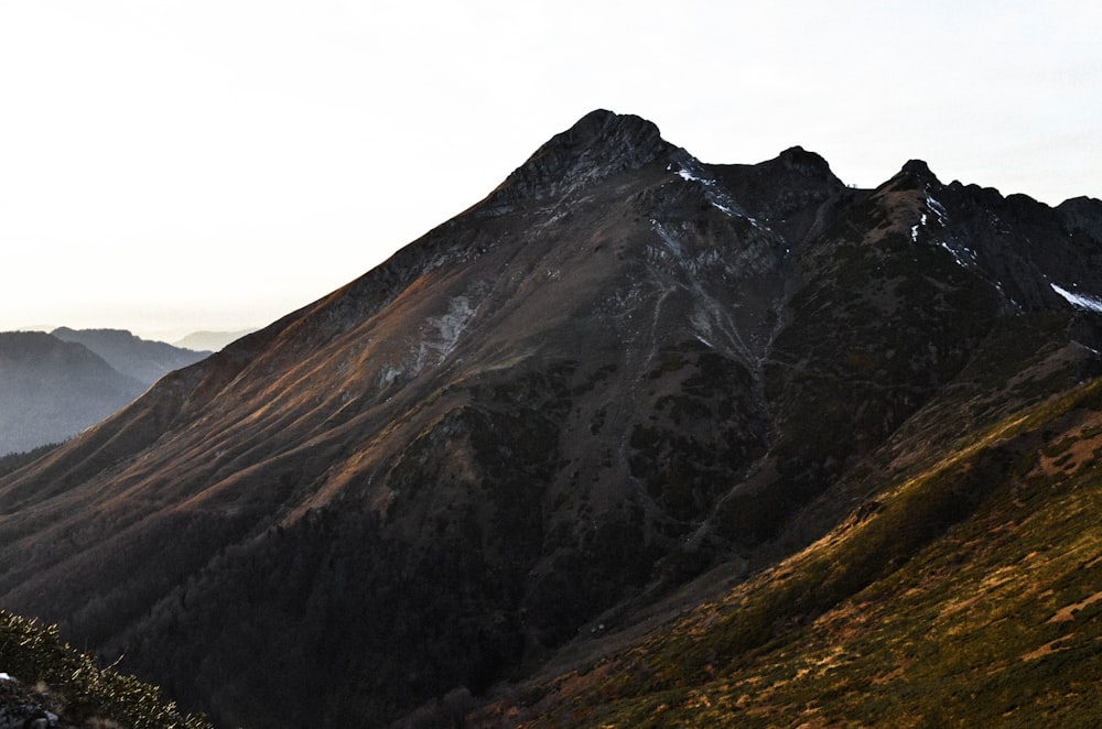 green and brown mountain under white sky during daytime