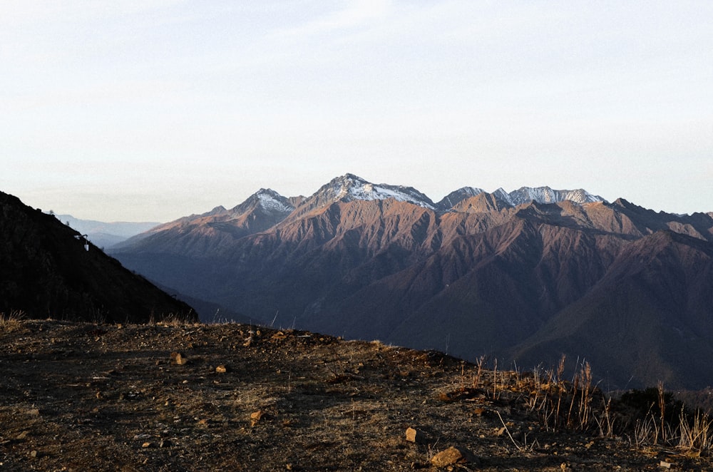 brown and black mountains under white sky during daytime