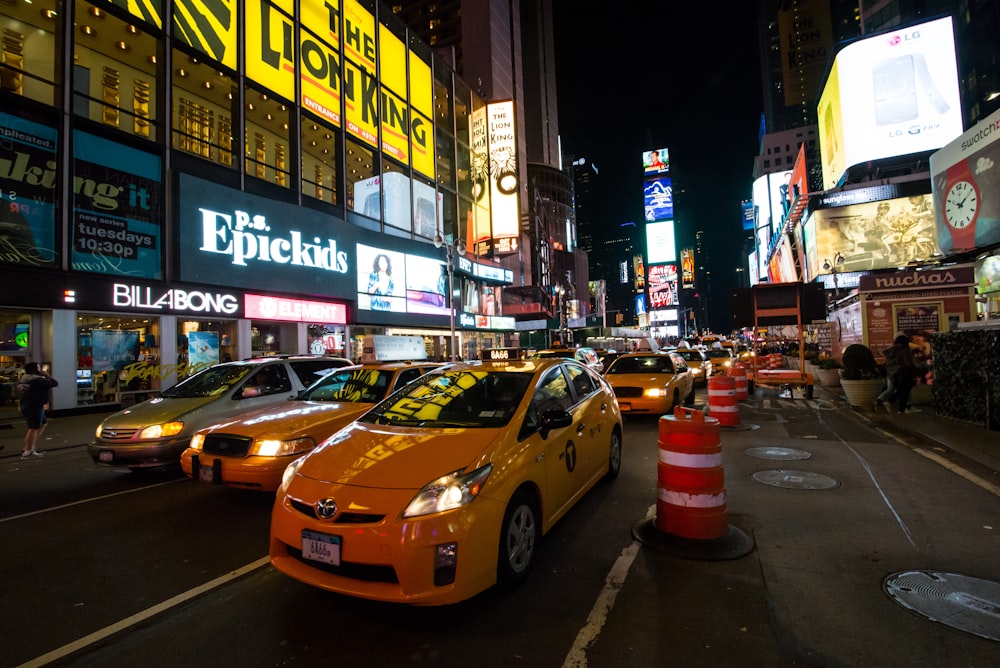 yellow taxi cab on road during night time