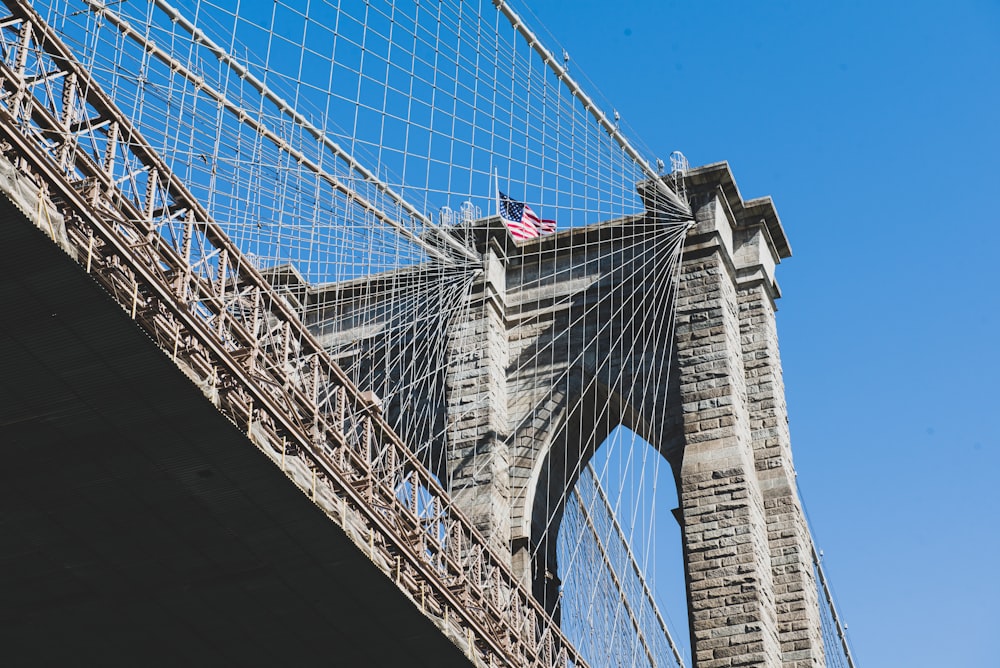 woman in black jacket standing on bridge during daytime