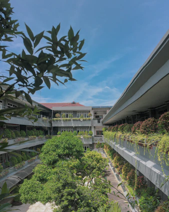 A bright, modern residential building with lush greenery and clear blue skies at Arihant Seasons.