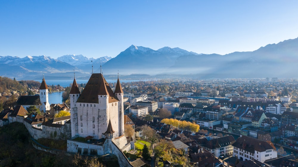 white and brown concrete castle near mountain during daytime