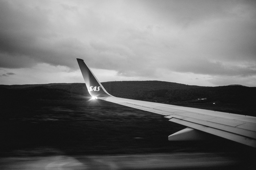 grayscale photo of airplane wing