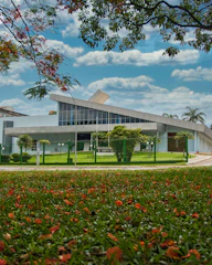 Institutional building with clean architectural lines surrounded by greenery.