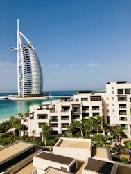 white and brown concrete building near body of water during daytime