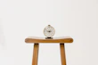Editorial style photo of a vintage flip clock on a minimalist ivory background