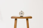 Editorial style photo of a vintage flip clock on a minimalist ivory background