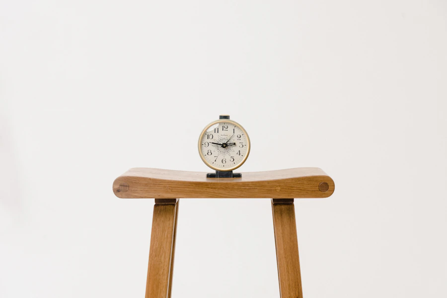 Wooden and brass desk clock on a table