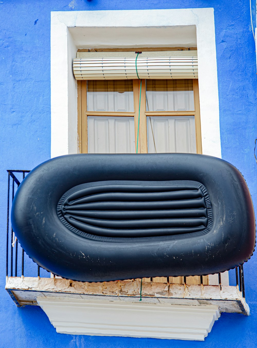 black car tire near blue concrete building during daytime