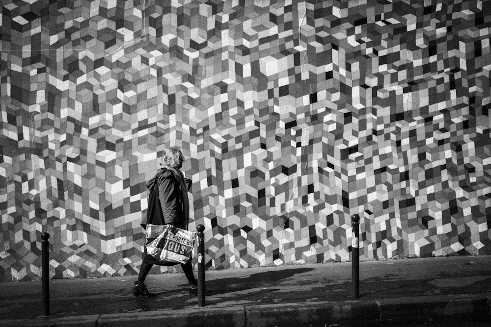 grayscale photo of man sitting on chair