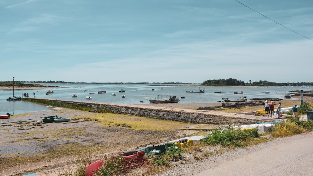 red and white boat on sea shore during daytime