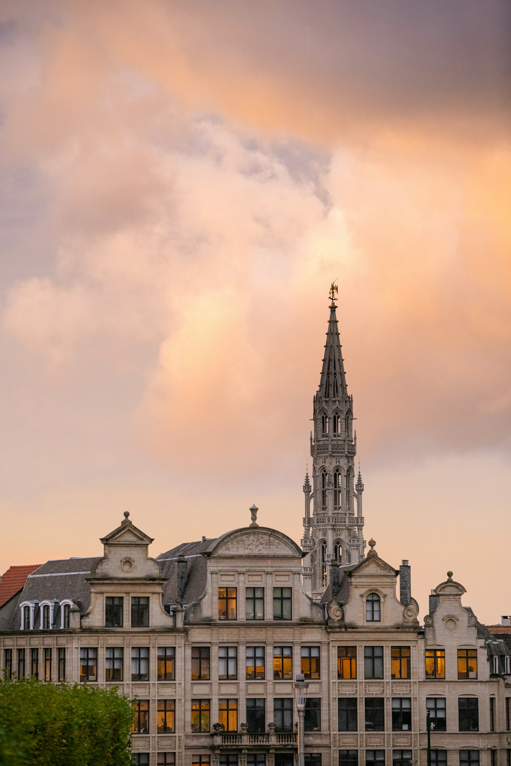 white and brown concrete building under cloudy sky during daytime