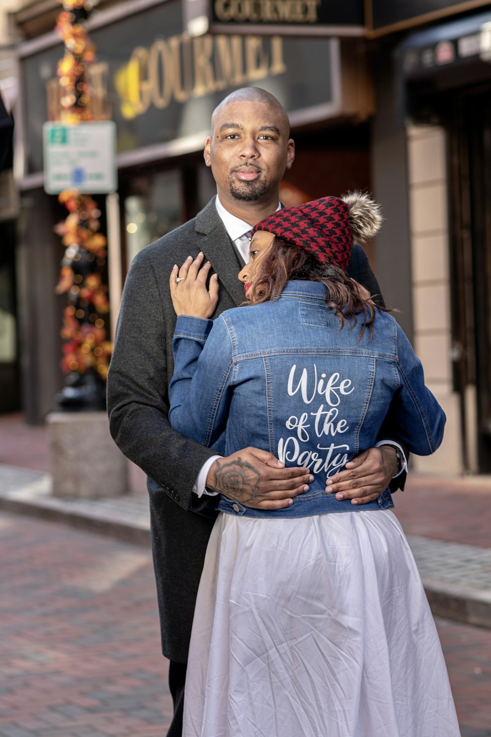 man in blue blazer and white dress