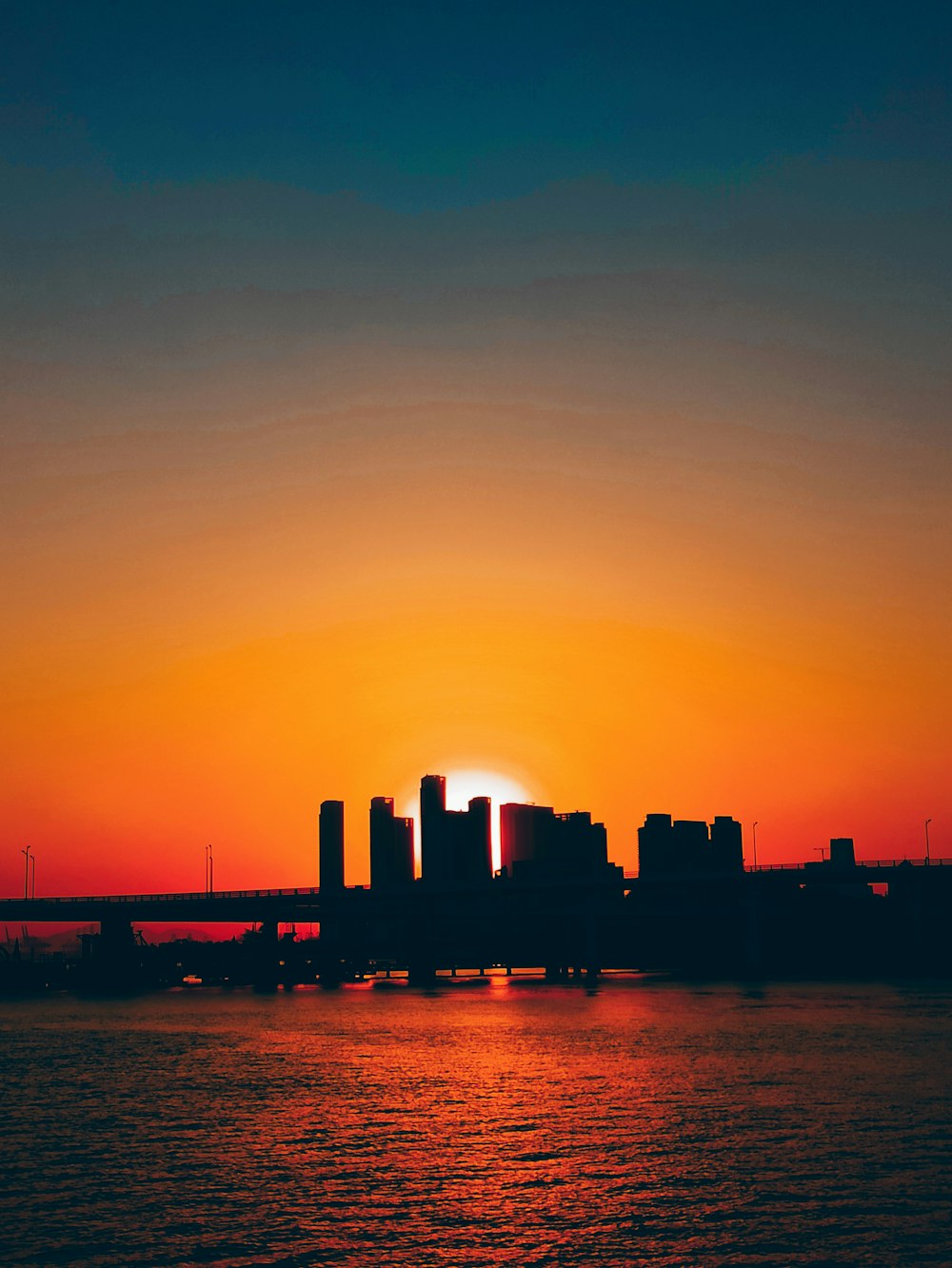 silhouette of city buildings during sunset