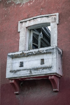 white wooden window on red concrete wall